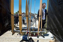 Axy Pagan-Vasquez, a mechanical engineer with the U.S. Army Corps of Engineers, explains how low-velocity wind energy is being captured using flexible strips of material during the Department of Defense Lab Day at the Pentagon. The US Army Corps of Engineers' Engineer Research and Development Center is developing the technology for use in conditions beyond suitable for wind turbines.
