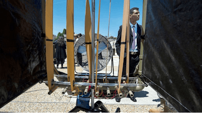 Axy Pagan-Vasquez, a mechanical engineer with the U.S. Army Corps of Engineers, explains how low-velocity wind energy is being captured using flexible strips of material during the Department of Defense Lab Day at the Pentagon. The US Army Corps of Engineers' Engineer Research and Development Center is developing the technology for use in conditions beyond suitable for wind turbines.