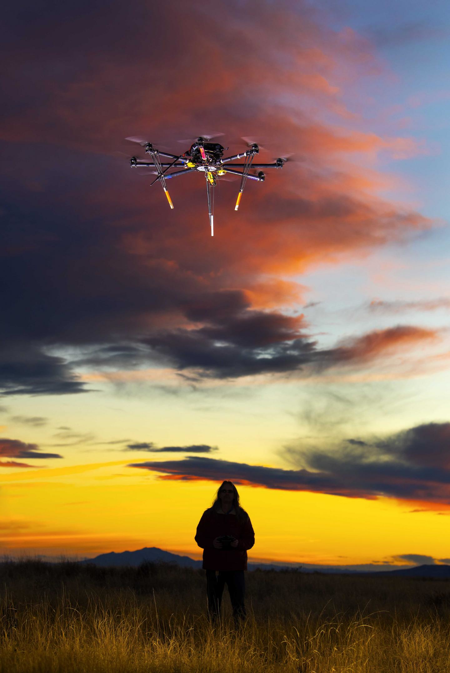 A pilot flies a drone at dusk. Humans might see their roles throughout aviation and aerospace shift if Sandia National Laboratories can simplify manual tasks with artificial intelligence.