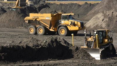 In this Nov. 14, 2017 file photo, crews with Duke Energy continue to remove coal ash from the old coal ponds at the Sutton Plant, in Wilmington, N.C. Duke Energy Corp., the country’s largest electric company, was ordered Monday, April 1, 2019 to excavate coal ash from all of its North Carolina power plant sites, slashing the risk of toxic chemicals leaking into water supplies but potentially adding billions of dollars to the costs consumers pay.