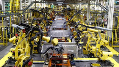 In this Sept. 27, 2018, file photo robots weld the bed of a 2018 Ford F-150 truck on the assembly line at the Ford Rouge assembly plant in Dearborn, Mich. On Monday, April 1, the Institute for Supply Management, a trade group of purchasing managers, issues its index of manufacturing activity for March.
