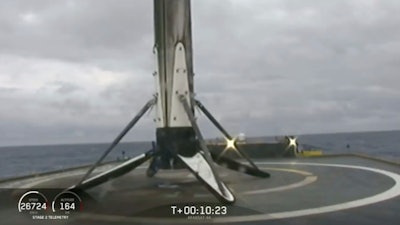 This Thursday, April 11, 2091 image from video made available by SpaceX shows a Falcon rocket booster shortly after landing on a barge in the Atlantic Ocean off Florida. On Tuesday, April 16, the company confirmed that the unsecured core booster toppled onto the platform over the weekend, as waves reached 8 to 10 feet. SpaceX chief Elon Musk says custom devices to secure the booster weren’t ready in time for this second flight of the Falcon Heavy.