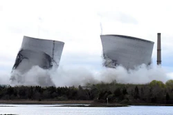 The two 500-foot cooling towers of the former Brayton Point Station collapse after explosive charges are detonated in Somerset, Mass., on Saturday, April 27, 2019. The plant had burned coal since 1963. By the time it stopped producing power in 2017, it was the last coal-fired plant in Massachusetts.