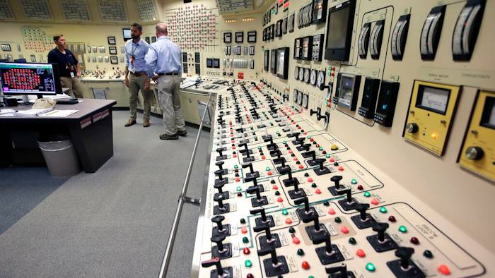 Senior Reactor Operator Christina Renaud, left, speaks with Training Supervisor Paul Gresh, center, and Control Room Supervisor Bob Sheridan, right, in the Control Room Simulator moments before a simulated reactor shutdown, Tuesday, May 28, 2019, at a training facility several miles from the Pilgrim Nuclear Power Station, in Plymouth, Mass. The simulated shutdown was performed in front of members of the media Tuesday ahead of the planned actual shutdown of the aging reactor on Friday, May 31.