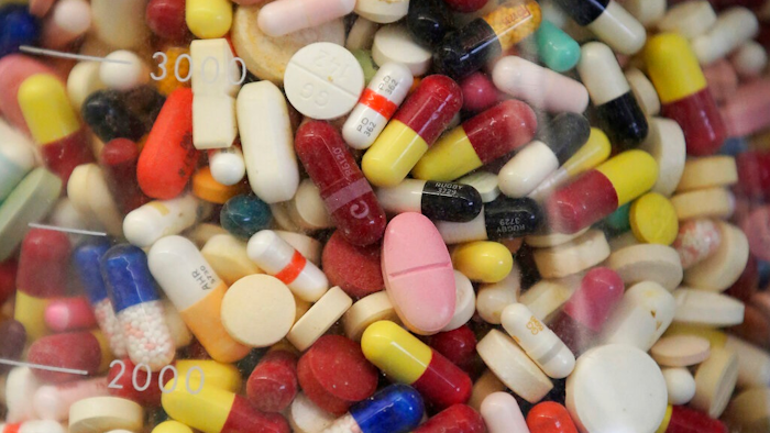 This July 6, 2017 file photo shows prescription drugs in a glass flask at the state crime lab in Taylorsville, Utah. Attorneys general from more than 40 states are alleging the nation's largest generic drug manufacturers conspired to artificially inflate and manipulate prices for more than 100 different generic drugs, including treatments for diabetes, cancer, arthritis and other medical conditions. The lawsuit, filed in federal court Friday, May 10, 2019 also names 15 individual senior executives responsible for sales, marketing and pricing.