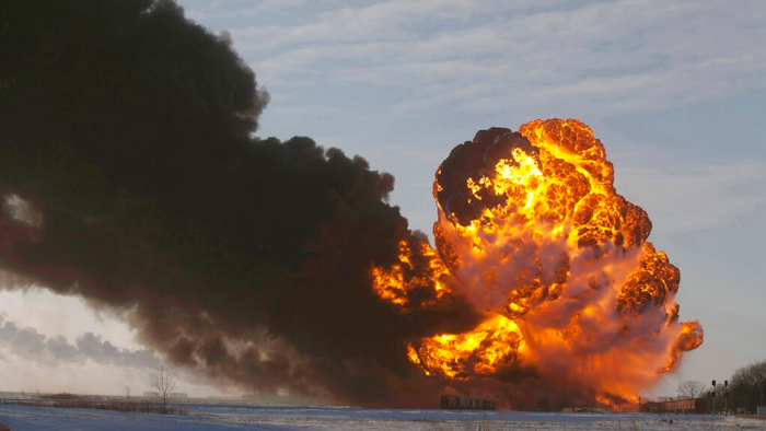 In this Dec. 30, 2013 file photo, a fireball goes up at the site of an oil train derailment near Casselton, N.D. The Trump administration is withdrawing a proposal for freight trains to have at least two crew members that was drafted in response to explosions of crude oil trains in the U.S. and Canada. Transportation officials said Thursday, May 23, 2019 that a review of accident data did not support the notion that having one crew member is less safe than a multi-person crew.