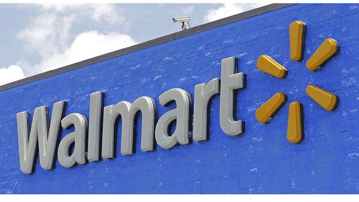 This June 1, 2017, file photo, shows a Walmart sign at a store in Hialeah Gardens, Fla. Walmart is rolling out next-day delivery on its most popular items, raising the stakes in the retail shipping wars. The nation’s largest retailer says Tuesday, May 13, 2019, it's been building its own network of more efficient e-commerce distribution centers to enable the faster delivery.
