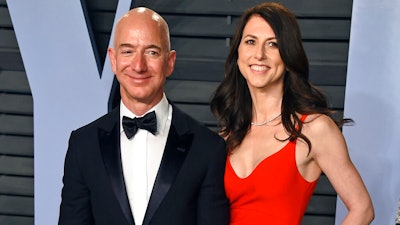 In this March 4, 2018 file photo, Jeff Bezos and wife MacKenzie Bezos arrive at the Vanity Fair Oscar Party in Beverly Hills, Calif. MacKenzie Bezos is pledging half her fortune to charity, following in the footsteps of billionaires Warren Buffett and Bill Gates. The ex-wife of Amazon founder and CEO Jeff Bezos finalized her divorce in April 2019 and reportedly got a stake in the online shopping giant worth over $35 billion.