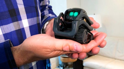 In this July 30, 2018, file photo, Anki Inc. CEO Boris Sofman holds Vector, the company's new home robot, in New York. The wheeled robot is designed as a successor to the San Francisco company's toy robot, Cozmo, which was introduced in 2016. Hopes that the tech industry was on the cusp of rolling personal robots into homes are dimming now that several once-promising consumer robotics companies have shut down.