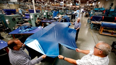 In this July 5, 2018, file photo workers assemble the Afloat water mattresses at the factory in Corona, Calif. On Wednesday, May 15, 2019, the Federal Reserve reports on U.S. industrial production for April.