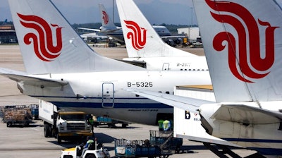 In this Aug. 29, 2007, file photo, Air China passenger airliners park at the Beijing International Airport in Beijing, China. Air China Ltd., one of China's three major state-owned airlines, is joining carriers that are asking Boeing Co. for compensation for the grounding of their 737 Max jetliners following two fatal crashes.