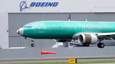 In this April 10, 2019, file photo, a Boeing 737 Max 8 airplane being built for India-based Jet Airways lands following a test flight at Boeing Field in Seattle. From airplanes made by Boeing to apples, cherries and wheat grown by farmers, no other state is more dependent on international trade than Washington. As the tariff disputes escalate, small factories are closing and manufacturing behemoths like Boeing are increasingly worried about access to crucial Asian markets that have helped propel the state's booming economy.
