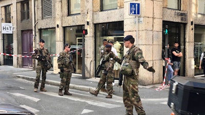 Soldiers of French anti terrorist plan 'Vigipirate Mission', secure the area near the site of a suspected bomb attack in central Lyon.
