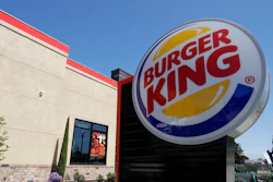 This April 25, 2019, file photo shows a Burger King in Redwood City, Calif. The company that owns the Burger King, Popeyes and Tim Hortons chains is expanding delivery in the U.S. and will accelerate restaurant openings worldwide in an ambitious growth plan. Restaurant Brands International said Wednesday, May 15, at its investor conference in New York that it plans to have 40,000 restaurants in operation globally over the next eight to 10 years, up from the current 26,000.