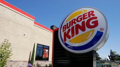 This April 25, 2019, file photo shows a Burger King in Redwood City, Calif. The company that owns the Burger King, Popeyes and Tim Hortons chains is expanding delivery in the U.S. and will accelerate restaurant openings worldwide in an ambitious growth plan. Restaurant Brands International said Wednesday, May 15, at its investor conference in New York that it plans to have 40,000 restaurants in operation globally over the next eight to 10 years, up from the current 26,000.