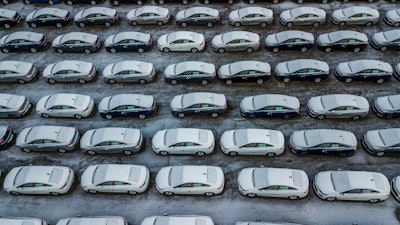 In this Dec. 5, 2018 file photo, hundreds of Chevrolet Cruze cars sit in a parking lot at General Motors' assembly plant in Lordstown, Ohio. A potential deal to sell the shuttered General Motors plant is still leaving the factory with an uncertain future. In May 2019, GM confirmed that it’s negotiating the sale of the massive assembly plant.