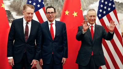 In this file photo taken Wednesday, May 1, 2019, Chinese Vice Premier Liu He, right, gestures as U.S. Treasury Secretary Steven Mnuchin, center, chats with his Trade Representative Robert Lighthizer, left, before they proceed to their meeting at the Diaoyutai State Guesthouse in Beijing. President Donald Trump turned up the pressure on China on Sunday, May 5, threatening to hike tariffs on $200 billion worth of Chinese goods. Trump's comments, delivered on Twitter, came as a Chinese delegation was scheduled to resume talks in Washington on Wednesday aimed at resolving a trade war that has shaken financial markets and cast gloom over the world economy.