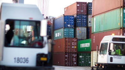 In this July, 5, 2018, file photo, two jockey truck drivers pass each other in the container yard where rubber tire gantry load and unload 40-foot shipping container at the Port of Savannah in Savannah, Ga. President Donald Trump turned up the pressure on China Sunday, May 5, 2019, threatening to hike tariffs on $200 billion worth of Chinese goods.