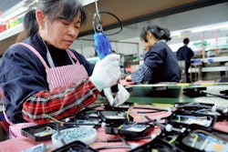 In this Saturday, March 30, 2019, file photo, workers assemble LED lights at a factory in Yushan county in central China's Jiangxi province. China is cutting taxes on its fledgling software and integrated circuit industries to spur development in the face of U.S. export controls that threaten to handicap Chinese tech companies.