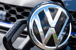 In this Tuesday, May 14, 2019 photo an e-Golf car is fixed with a charging station during a press tour at the plant of the German manufacturer Volkswagen AG (VW) in Zwickau, Germany. Volkswagen will total shift into electric cars at the plant in Zwickau and the first vehicles are to roll off the assembly line at the end of 2019.