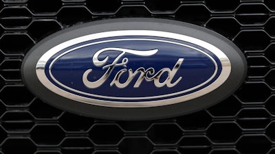 In this Feb. 17, 2019, file photo the company logo is displayed on the grille of an unsold 2019 F150 pickup truck at a Ford dealership in Broomfield, Colo. Ford is almost finished with a major global restructuring, and by the time it ends in August the automaker will have shed 7,000 white-collar jobs. The company said Monday, May 20 that the plan will save about $600 million per year by eliminating bureaucracy and increasing the number of workers reporting to each manager.