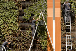 In this April 9, 2019, photo gardeners work on a vertical planters in Philadelphia. On Tuesday, April 30, the Labor Department releases the employment cost index for the first quarter, a measure of wage and benefit growth.