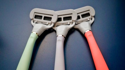 In this Oct. 11, 2018 file photo razors from Harry's shaving and body care brand Flamingo are displayed in New York. Edgewell Personal Care is acquiring upstart razor maker Harry’s in a cash-and-stock deal for $1.37 billion. Edgewell and other larger personal care companies have been steadily losing market share to smaller, direct-to-consumer companies like Harry’s, known for its brightly-colored disposable razors.