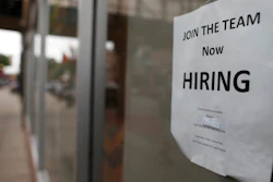 In this July 18, 2018, file photo a 'now hiring' sign hangs in the window of a Chinese restaurant in downtown Fargo, N.D. Small business hiring is slowing, according to numbers released by payroll provider ADP.