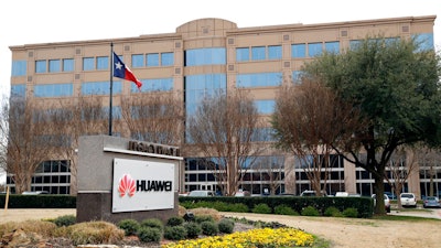 In this Thursday, March 7, 2019 file photo, the Texas state flag files outside the Huawei Technologies Ltd. business location in Plano, Texas. President Donald Trump issued an executive order Wednesday, May 15, 2019, apparently aimed at banning equipment from Chinese telecommunications giant Huawei from U.S. networks. It does not name specific countries or companies and gives the Department of Commerce 150 days to come up with regulations.