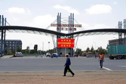 In this March 21, 2018 file photo, people walk past the gate of the Eastern Industrial Zone in Ethiopia in the town of Dukem near the capital, Addis Ababa. Ethiopian garment factory workers are now, on average, the lowest paid in any major garment-producing company worldwide, a new report said Tuesday, May 7, 2019.