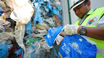 Officers from the Ministry of Environment examine a container full of non-recyclable plastic which was detained by authorities at the west port in Klang, Malaysia, Tuesday, May 28, 2019. Malaysia environment minister Yeo Bee Yin says Malaysia has become a dumping ground for the world's plastic waste, and the country has begun sending non-recyclable plastic scrap to the developed countries of origin.
