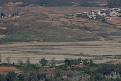 In this May 6, 2019, photo, North Korea's Kaepoong town is seen behind a North Korean military guard post. North Korea says it is suffering its worst drought in nearly four decades amid concern about a food crisis in the country.