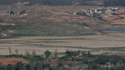In this May 6, 2019, photo, North Korea's Kaepoong town is seen behind a North Korean military guard post. North Korea says it is suffering its worst drought in nearly four decades amid concern about a food crisis in the country.