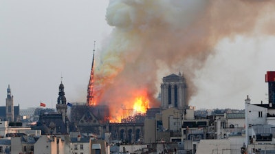 In this April 15, 2019 file photo, flames rise from Notre Dame cathedral as it burns in Paris. Notre Dame Cathedral's melted roof has left astronomically high lead levels in the plaza outside and adjacent roads. Paris police say lead levels from the roof were found to be between 10 and 20 grams per kilogram of ground — between 32 and 65 times the recommended limit by French health authorities of 0.3 grams per kilogram.