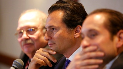 In this Aug. 17, 2017 file photo, flanked by lawyer Javier Coello Trejo, left, Emilio Lozoya, former head of Mexico's state-owned oil company Pemex, attends a press conference, in Mexico City. The head of Mexico’s financial intelligence unit says that the former Pemex executive who was sanctioned Wednesday, May 22, 2019, by the comptroller’s office is Lozoya.