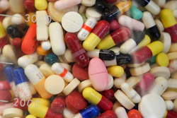 This July 6, 2017 file photo shows prescription drugs in a glass flask at the state crime lab in Taylorsville, Utah. Attorneys general from more than 40 states are alleging the nation's largest generic drug manufacturers conspired to artificially inflate and manipulate prices for more than 100 different generic drugs, including treatments for diabetes, cancer, arthritis and other medical conditions. The lawsuit, filed in federal court Friday, May 10, 2019 also names 15 individual senior executives responsible for sales, marketing and pricing.