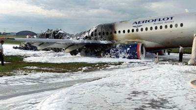 The Sukhoi Superjet 100 aircraft of Airflot Airlines, center, is seen after an emergency landing in Sheremetyevo airport in Moscow, Russia, Sunday, May 5, 2019.