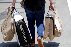 In this July 3, 2018, file photo, a shopper carries bags in San Francisco. American consumers are feeling more confident this April 2019, though optimism hasn’t fully recovered from a period of roiling markets and slowed hiring early this year. The Conference Board, a business research group, said Tuesday, April 30, 2019, that its consumer confidence index rose to 129.2 in April, from 124.2 in March.