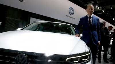 Herbert Diess, CEO of the Volkswagen stock company, poses next to a Volkswagen car prior to the company's annual general meeting in Berlin, Germany, Tuesday, May 14, 2019.