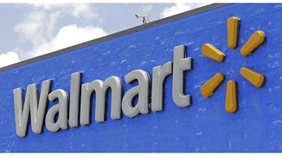 This June 1, 2017, file photo, shows a Walmart sign at a store in Hialeah Gardens, Fla. Walmart is rolling out next-day delivery on its most popular items, raising the stakes in the retail shipping wars. The nation’s largest retailer says Tuesday, May 13, 2019, it's been building its own network of more efficient e-commerce distribution centers to enable the faster delivery.