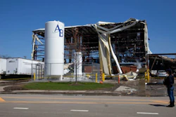 Debris can be seen as emergency personnel and others search and clear the scene of an explosion and fire at AB Specialty Silicones chemical plant Saturday, May 4, 2019, in Waukegan, Ill. An explosion and fire at an Illinois silicone factory was believed to have killed three people, authorities said Saturday, as they recovered the body of one victim while suspending the search for the other two.
