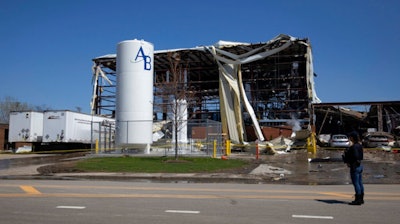 Debris can be seen as emergency personnel and others search and clear the scene of an explosion and fire at AB Specialty Silicones chemical plant Saturday, May 4, 2019, in Waukegan, Ill. An explosion and fire at an Illinois silicone factory was believed to have killed three people, authorities said Saturday, as they recovered the body of one victim while suspending the search for the other two.