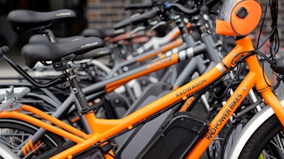 In this photo taken Wednesday, May 15, 2019, electric bicycles are lined-up outside Rad Power Bikes in Seattle, where the bicycle company said that they will absorb 100% of any tariff on their Chinese-made bicycles. From airplanes made by Boeing to apples, cherries and wheat grown by farmers, no other state is more dependent on international trade than Washington. As the tariff disputes escalate, small factories are closing and manufacturing behemoths like Boeing are increasingly worried about access to crucial Asian markets that have helped propel the state's booming economy.