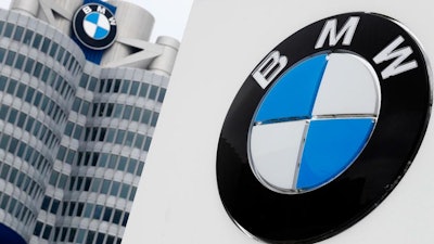In this March 21, 2018 file photo shows the logo of German car manufacturer BMW visible at the headquarters in Munich, Germany. German automaker BMW said Tuesday that its first quarter profit sagged by 74 percent as earnings were hit by a 1.4 billion-euro ($1.6 billion) set-aside for an anti-trust fine from the European Commission and by higher up-front costs for new technology and factories.