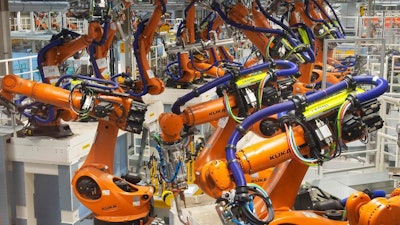 In this Tuesday, May 14, 2019 photo, robot arms stand at the assembly line during the reconstruction for the electrical car body construction at a press tour at the plant of the German manufacturer Volkswagen AG (VW) in Zwickau, Germany. Volkswagen will total shift into electric cars at the plant in Zwickau and the first vehicles are to roll off the assembly line at the end of 2019.