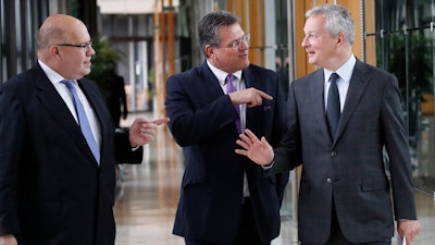 French Economy and Finance Minister Bruno Le Maire, right, his German counterpart Peter Altmaier, left, and European Commission Vice President Maros Sefcovic arrive for a press conference following a meeting in Paris, Thursday, May 2, 2019. France and Germany unveiled details of a plan to create a leading electric battery industry in Europe, from extraction of raw materials to recycling.