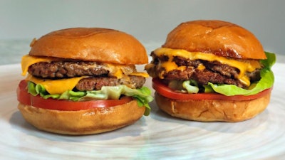 An Original Impossible Burger, left, and a Cali Burger, from Umami Burger, are shown in this photo in New York, Friday, May 3, 2019. A new era of meat alternatives is here, with Beyond Meat becoming the first vegan meat company to go public and Impossible Burger popping up on menus around the country.