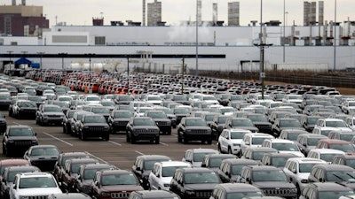 In this Feb. 26, 2019 file photo, Jeep vehicles are parked outside the Jefferson North Assembly Plant in Detroit. Fiat Chrysler can move forward with plans to build a new, $1.6 million assembly plant on Detroit's Eastside and invest $900 million to retool and modernize another. The Detroit City Council on Tuesday approved land deals and community benefits agreements tied to the project. They include a four-week exclusive window Detroit residents will have to apply for jobs at the facilities once laid-off workers and temporary employees are considered. Fiat Chrysler expects to add 4,950 new jobs.