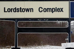 In this March 6, 2019, file photo, a 'Save Me' sign rests against the General Motors Lordstown Complex sign in Lordstown, Ohio. General Motors plans to sell its shuttered factory in Lordstown, to a company that builds electric trucks. President Donald Trump announced the deal Wednesday morning, May 8, 2019, on Twitter.