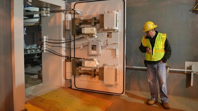 In this Oct. 27, 2015 file photo, a worker at the Blue Grass Chemical Agent Pilot Plant looks at a blast door inside the facility in Richmond, Ky. Senate Majority Leader Mitch McConnell, military leaders and Gov. Matt Bevin were in Richmond on Wednesday, May 29, 2019, to ceremonially mark the beginning of the elimination of more than 500 tons of mustard gas, sarin or VX agent stored at the Army depot.
